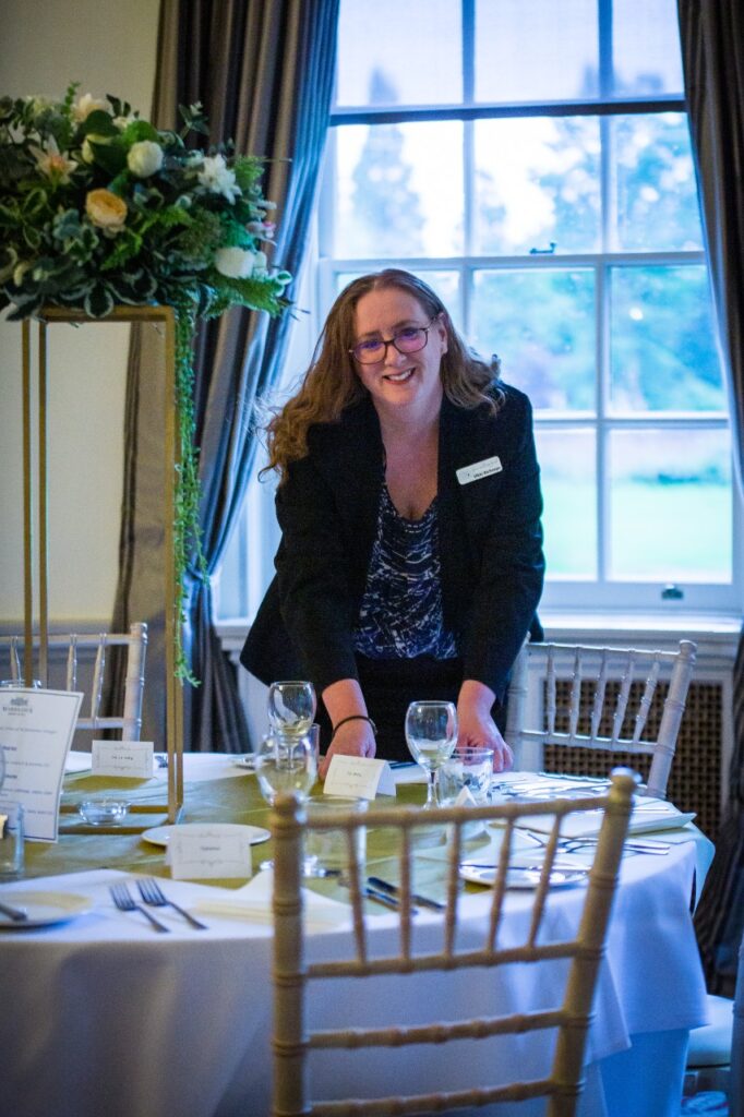 Your Wedding Friend setting up a guest wedding breakfast table